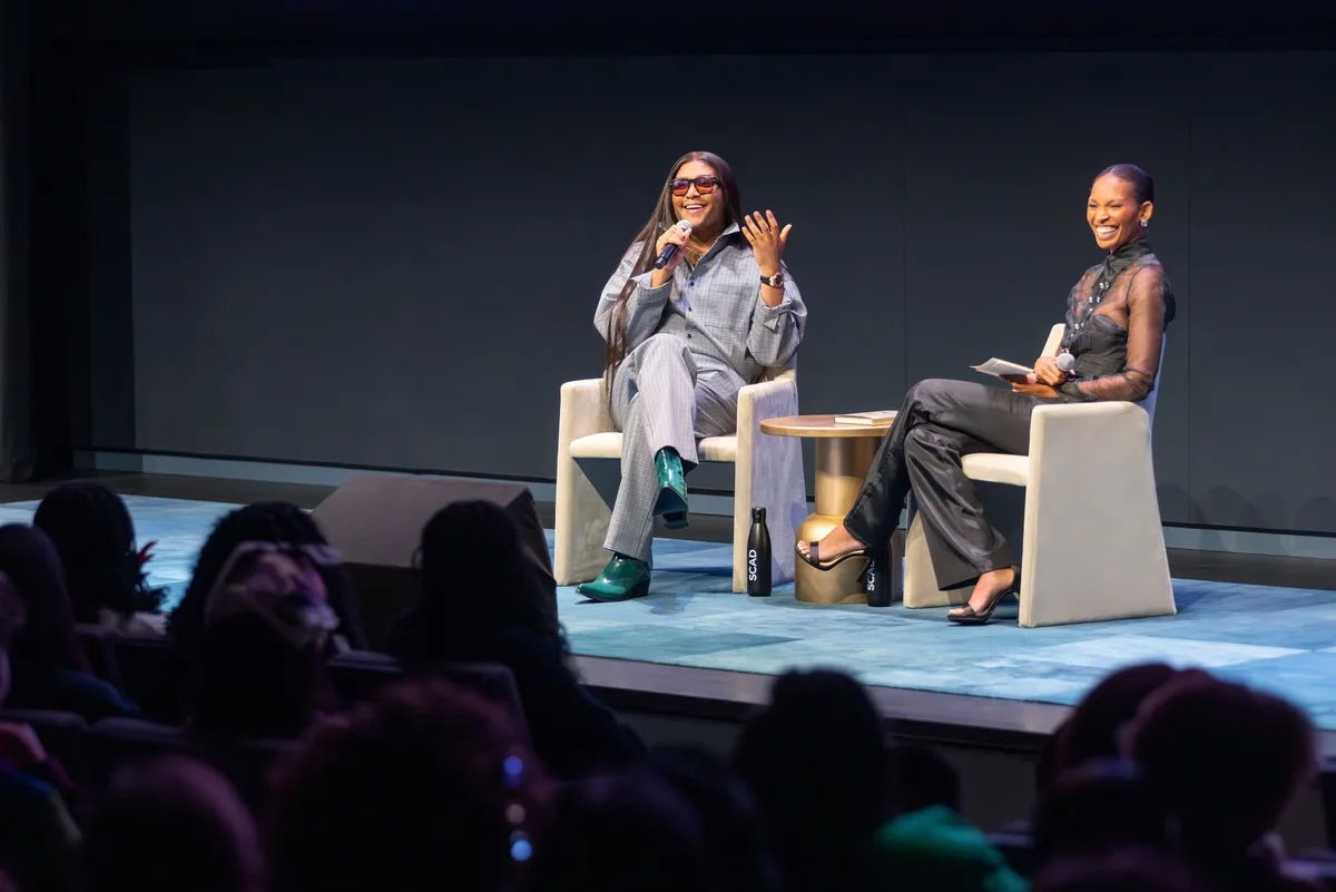 Alex Delotch Davis moderating a stage conversation