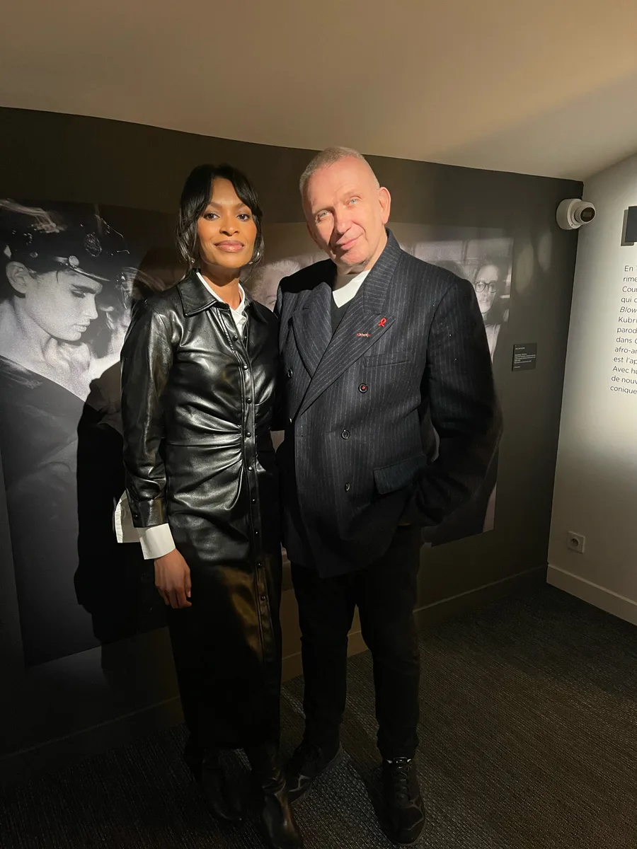 Alex Delotch Davis standing with Jean Paul Gaultier at an exhibition
